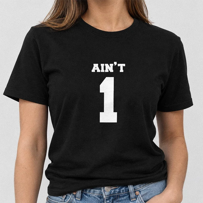 Woman wearing a black Funny Couples Matching Shirt for Her - 99 Problems Ain’t One T-Shirt with large bold white text reading AIN'T 1