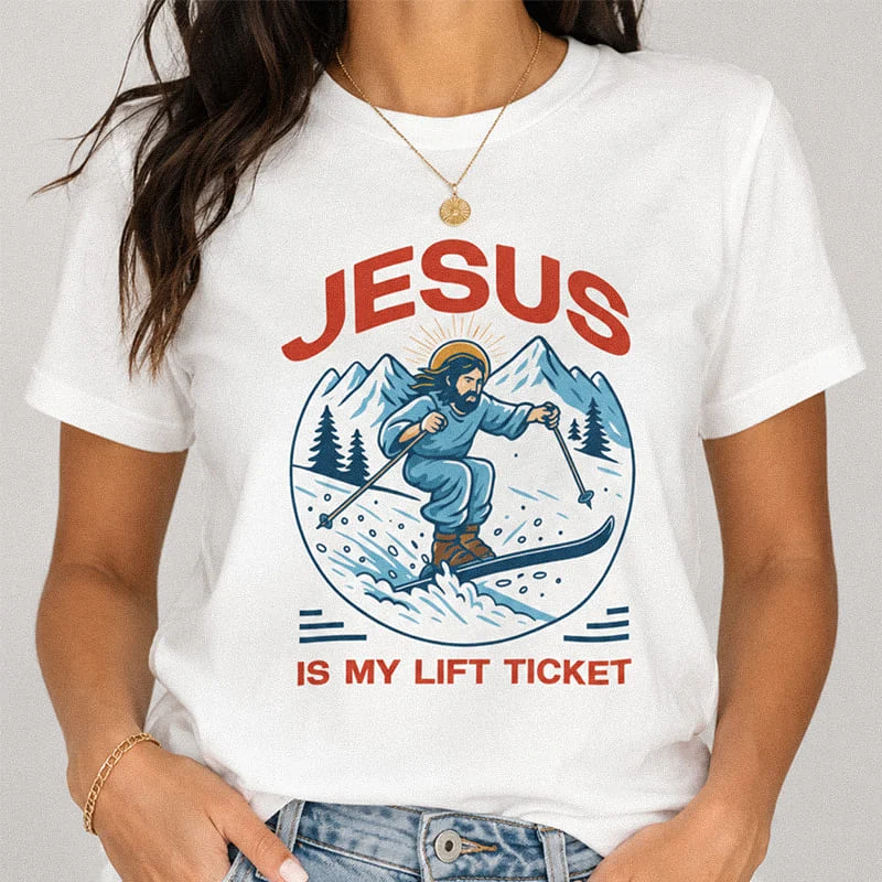 Woman wearing a white Jesus Is My Lift Ticket T-Shirt - Ski Shirt - Christian Skiing Shirt featuring a retro graphic of Jesus skiing down a snowy mountain with the text "Jesus Is My Lift Ticket"
