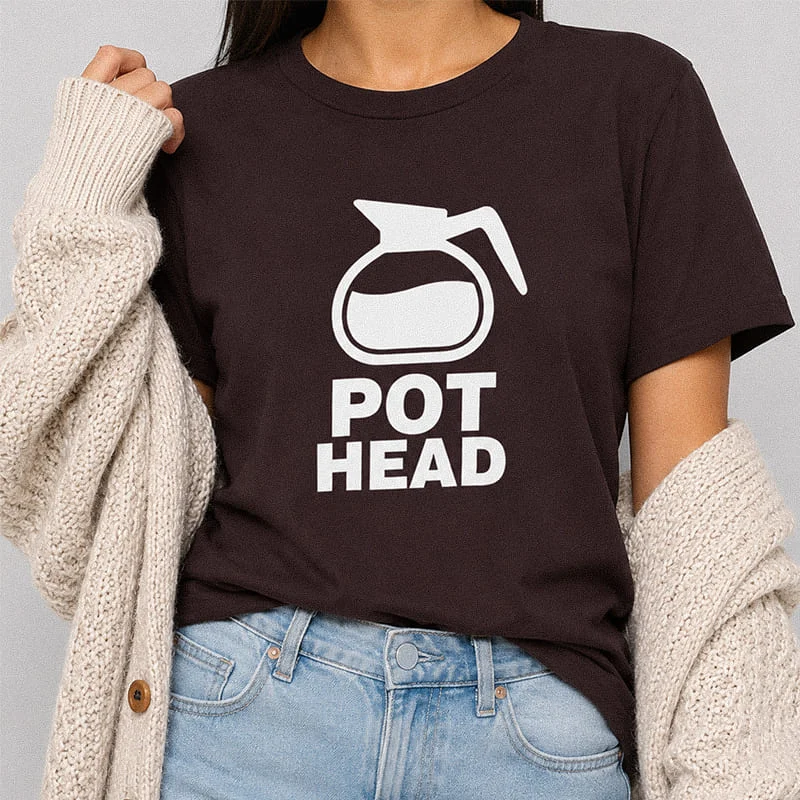 Woman wearing an oxblood black Pot Head Coffee Pot T-Shirt - Funny Coffee Lover Graphic Tee with a graphic of a coffee pot and the text "Pot Head"