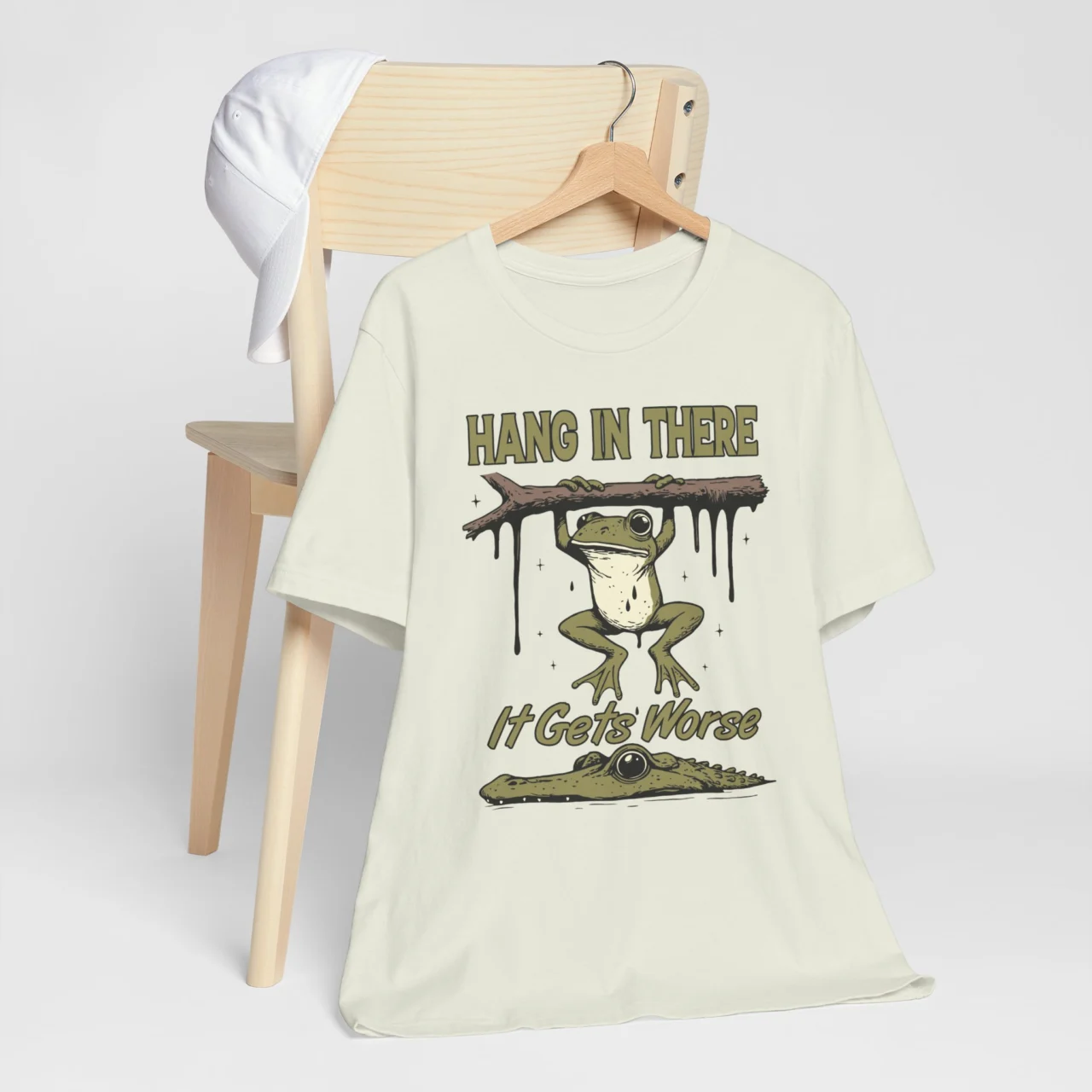 Cartoon frog hanging from branch over an alligator with text Hang in There It Gets Worse t-shirt