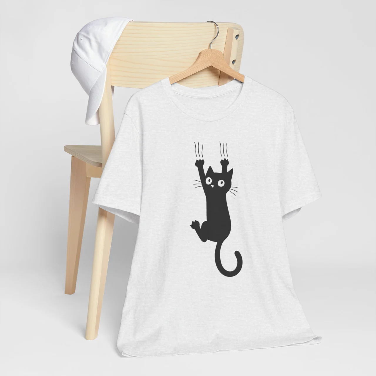 Cat Scratching T-Shirt with graphic of a cat hanging and scratching upward playfully