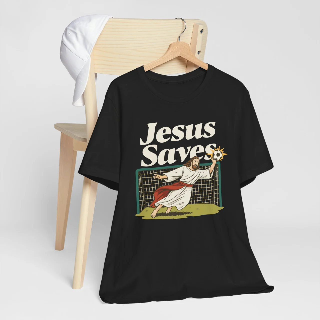 Funny Christian soccer Jesus Saves Soccer Shirt with Jesus diving as a goalkeeper, humorous religious sports shirt.
