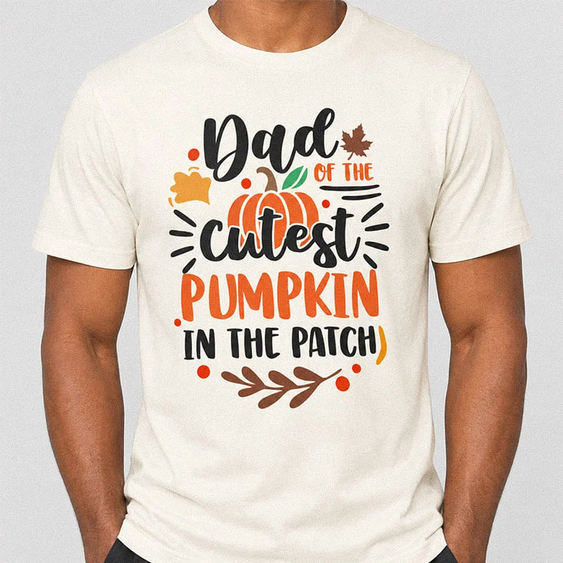 Man wearing an natural Dad of the Cutest Pumpkin in the Patch Shirt - Cute Fall Dad Tee featuring pumpkin and leaf graphics with the text Dad Of The Cutest Pumpkin In The Patch