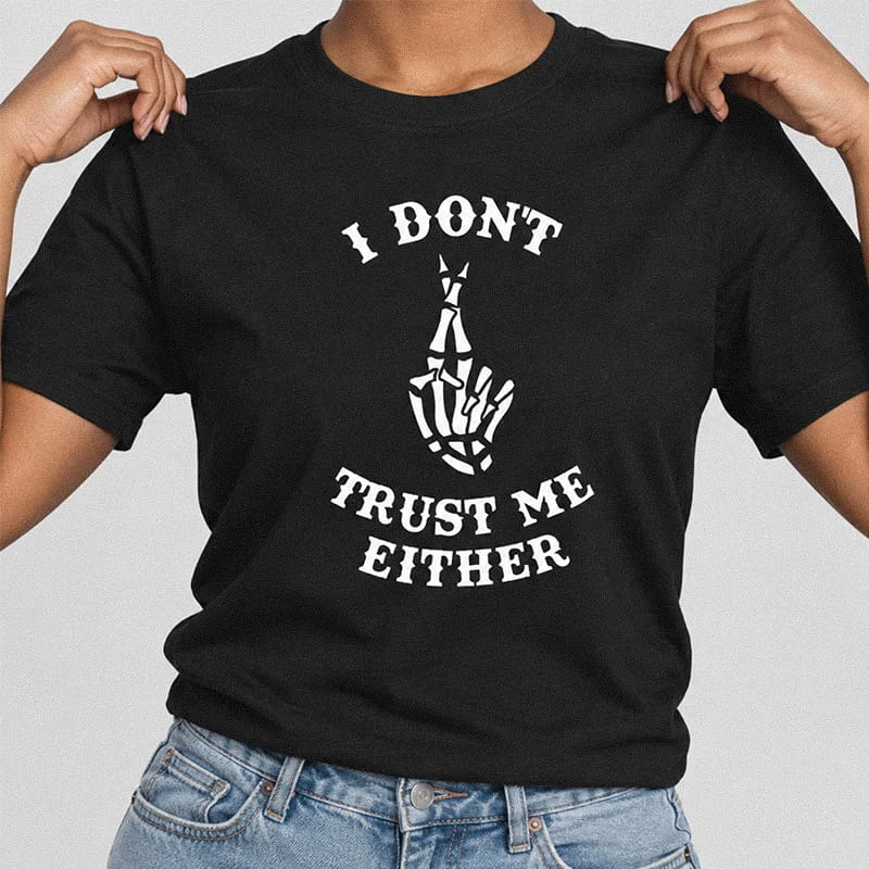Person wearing a black funny I Dont Trust Me Either Shirt - Crossed Skeleton Fingers Tee featuring a skeleton hand with fingers crossed.