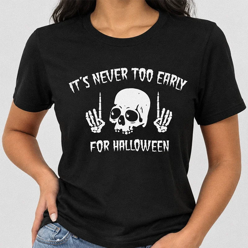 Woman wearing a black edgy Its Never Too Early for Halloween Shirt - Funny Skeleton Tee featuring a skull flanked by skeleton middle finger hands