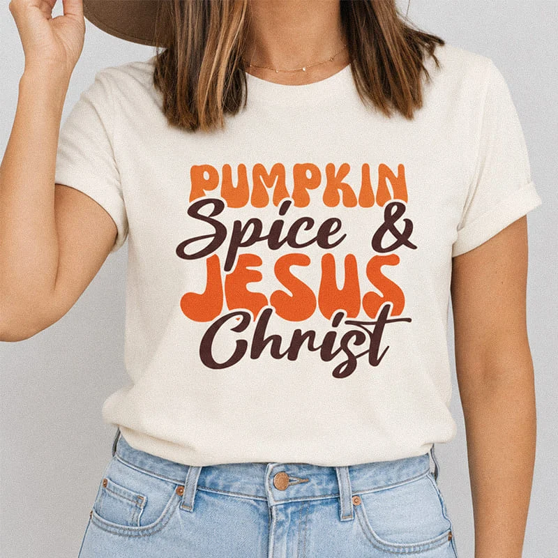 Woman wearing a natural Pumpkin Spice and Jesus Christ Shirt - Christian Halloween Tee featuring retro wavy lettering reading Pumpkin Spice and Jesus Christ