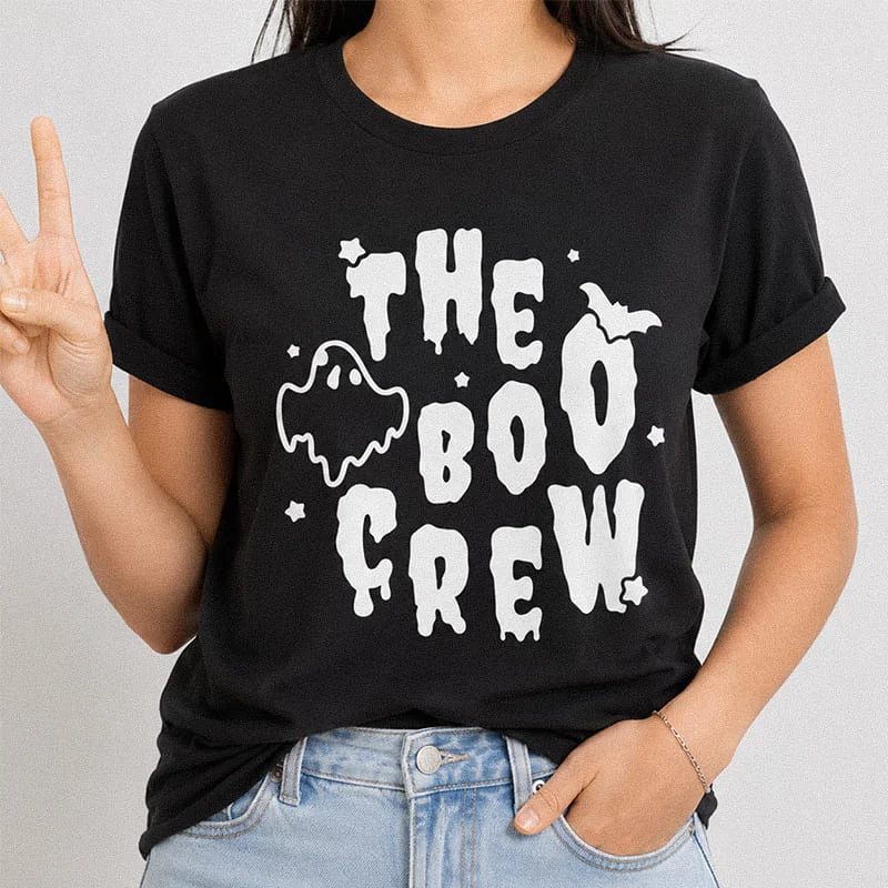 Woman wearing a black The Boo Crew Shirt - Funny Family Matching Halloween Tee featuring dripping text and a ghost graphic reading The Boo Crew
