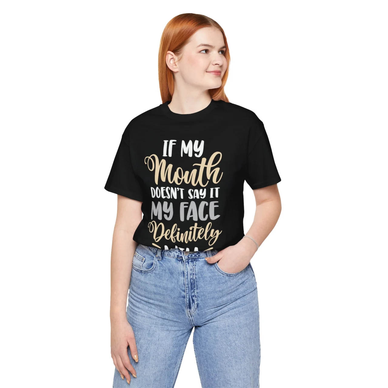 A woman dressed in a black If My Mouth Doesn't Say It My Face Definitely Will Sarcastic Graphic Tee posing with a friendly expression.