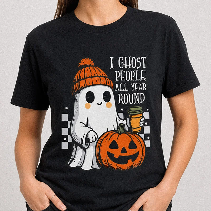 Woman wearing a black I Ghost People All Year Round Shirt - Funny Ghost Halloween Tee featuring a cute cartoon ghost holding a coffee cup next to a jack-o-lantern with the text "I Ghost People All Year Round"