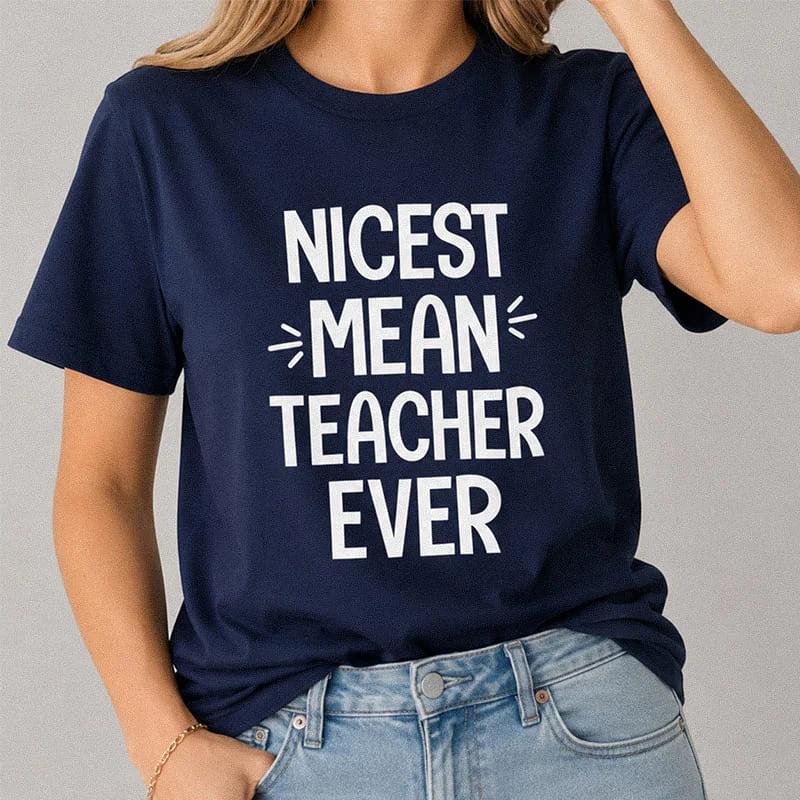 Woman wearing a navy blue Nicest Mean Teacher Ever Shirt - Funny Teacher Classroom Tee with bold typography reading "Nicest Mean Teacher Ever"