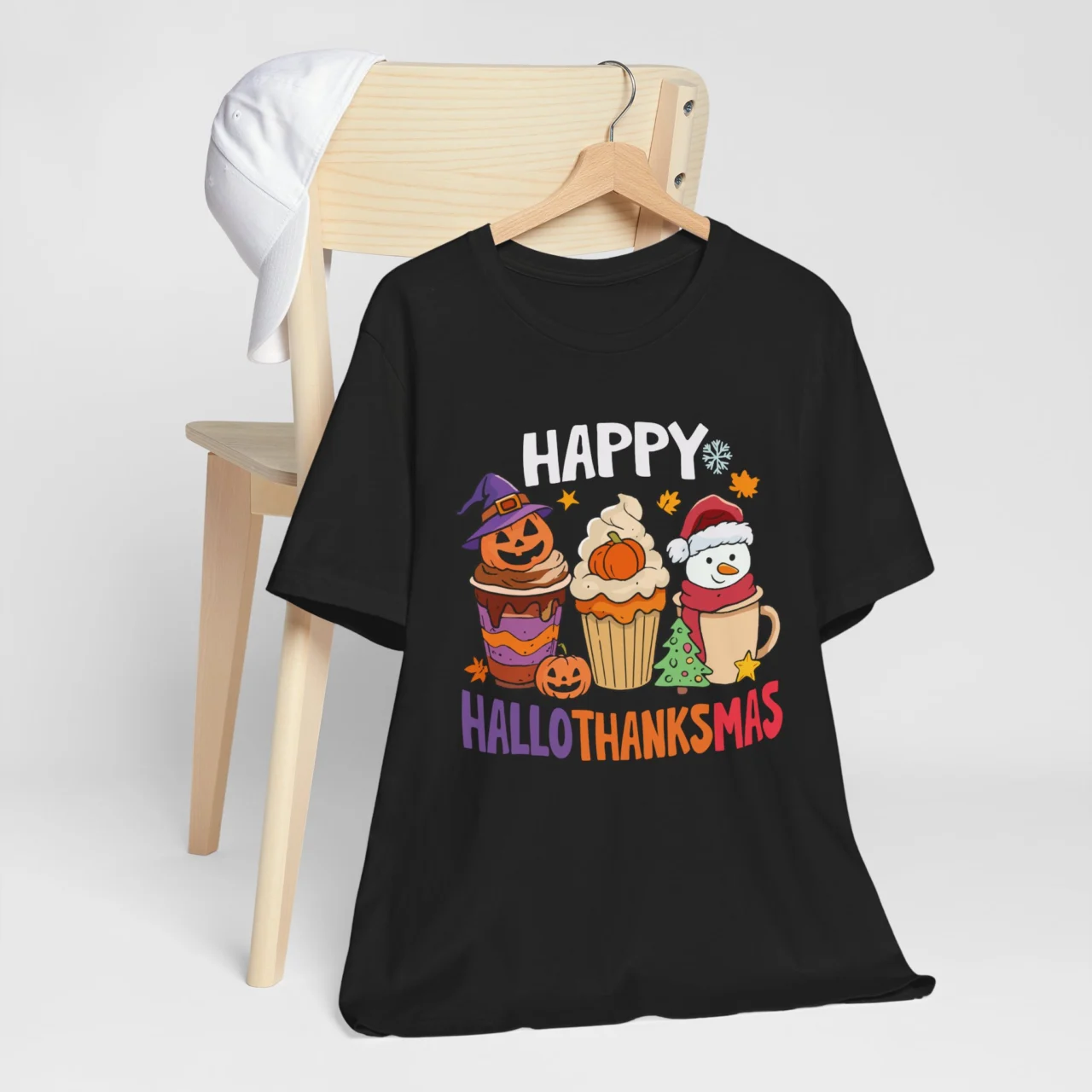 Black Hallothanksmas shirt with three festive cups: a Halloween witch cup, a Thanksgiving pumpkin cup, and a Christmas snowman cup, promoting a funny fall and winter holiday theme.