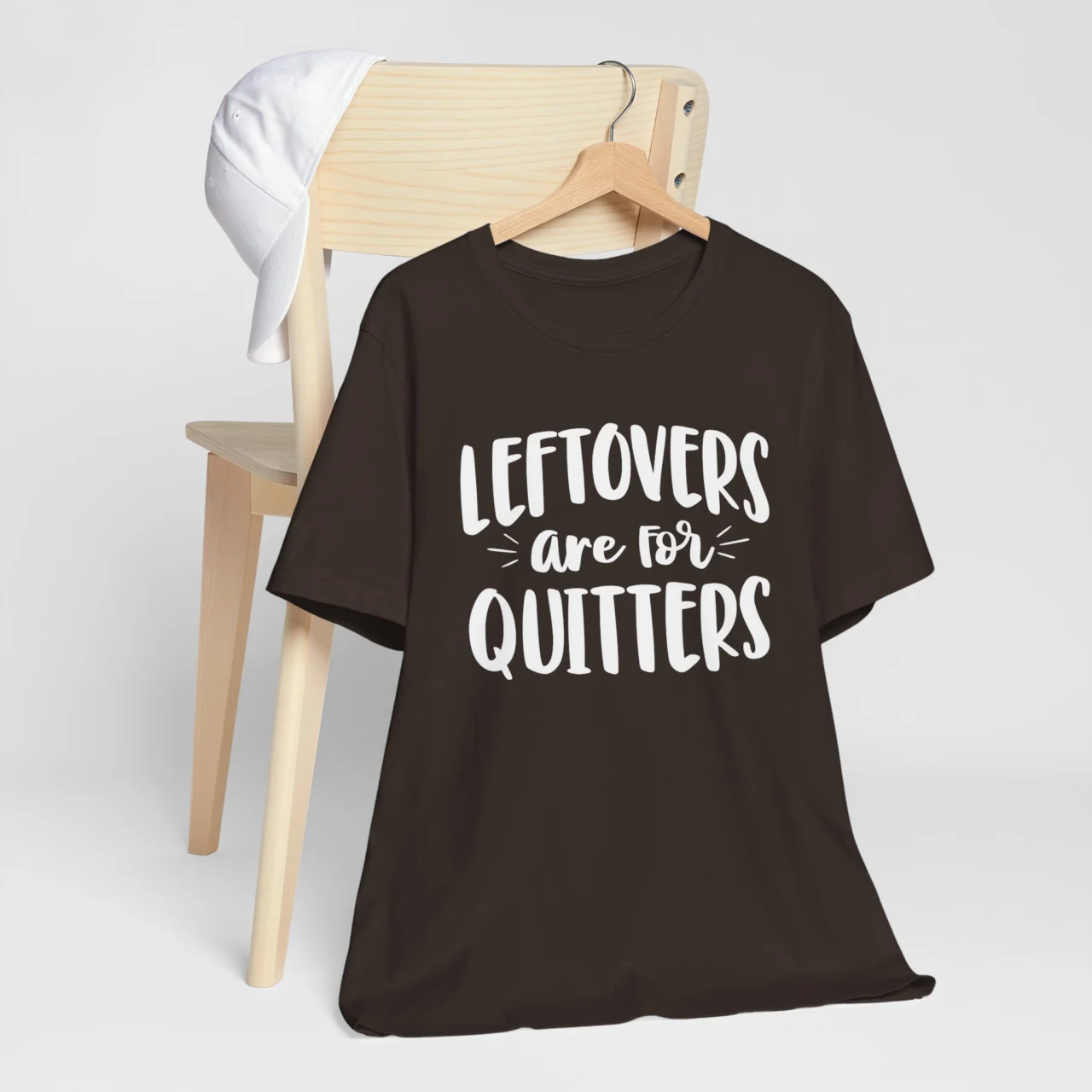 Leftovers are for Quitters Shirt in bold white typography on a dark brown t-shirt, a funny sarcastic Thanksgiving food humor design.
