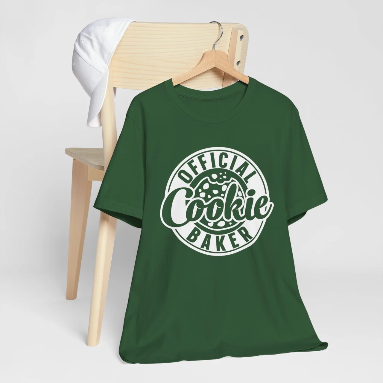 Official Cookie Baker Shirt in a white circular logo design on a dark green adult t-shirt, a Mom Matching Family Christmas Tee design.