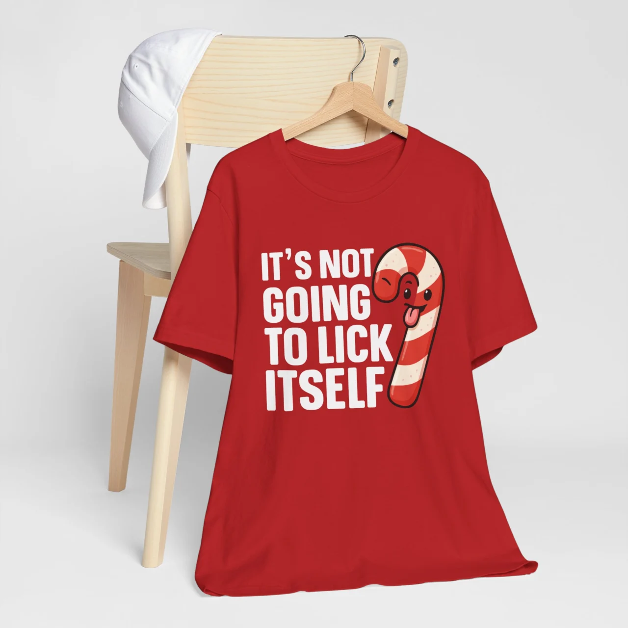It's Not Going to Lick Itself Shirt featuring a cartoon winking candy cane, a Funny Adult Flirty Christmas Tee design.
