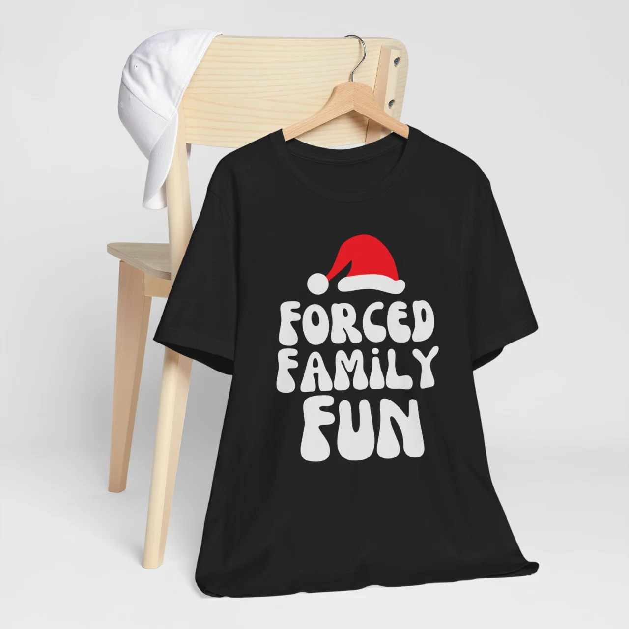 Forced Family Fun Shirt in white retro text and a red Santa hat on a black t-shirt, a Funny Sarcastic Christmas Holiday Tee design.