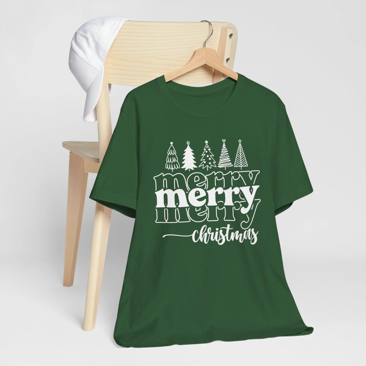 Merry Merry Christmas Shirt in white layered text with Christmas tree outlines, a Wholesome Festive Family Holiday Tee design.