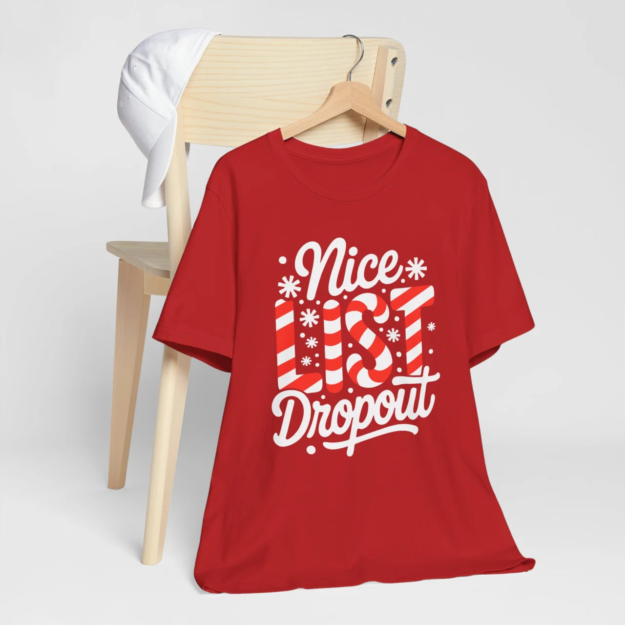 Nice List Dropout Shirt in white and red candy cane-style text on a red t-shirt, a Funny Sarcastic Christmas Naughty Tee design.