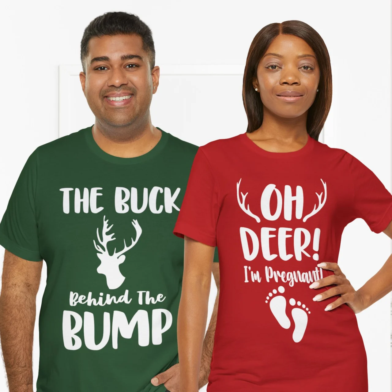 Matching Shirts Set featuring the The Buck Behind the Bump shirt (green) and the Oh Deer I'm Pregnant shirt (red), a festive Couple's Christmas Pregnancy Announcement Tees Set.